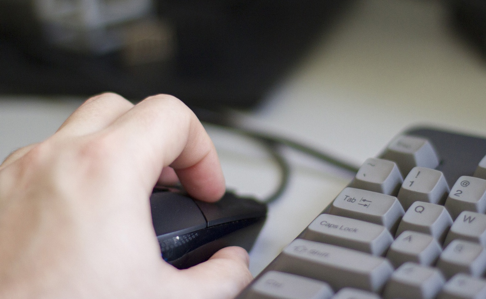 imagen de  la mano de una persona usando un mouse en una computadora